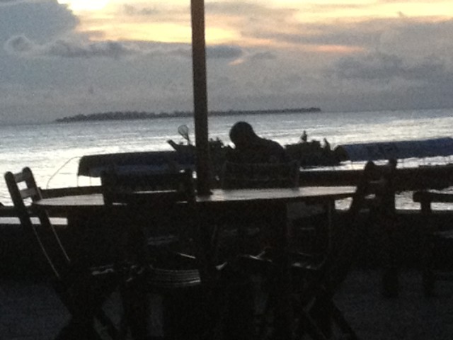 A person checking his phone at sunset. The power had just been out for a few minutes